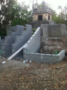 A stone wall with steps going up it
