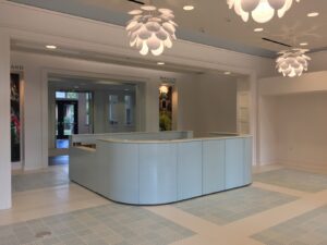 A large white reception desk in an office building.